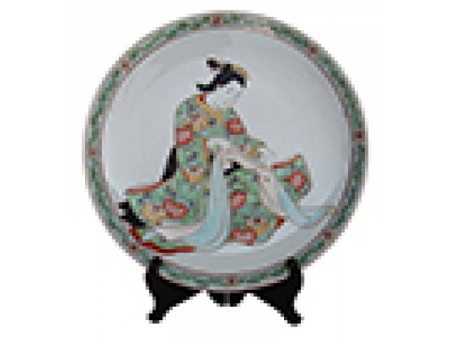 Prato porc. “Yamatoku” borda trabalhada padrão floral em tons de verdes e rosa, centro figura feminina costurando. d = 31 cm. - Japão, séc. XX